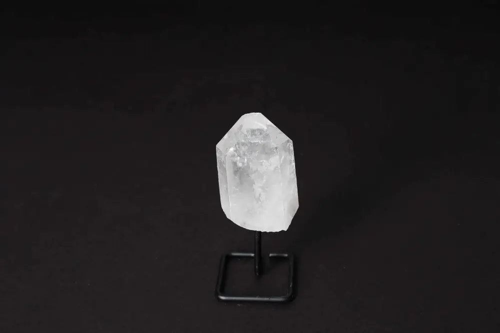 Natural Clear Quartz Point on stand for energy amplification, meditation, and clarity.