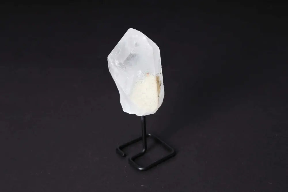 Clear Quartz point on a modern stand, enhancing energy and clarity, ideal for meditation and manifestation.