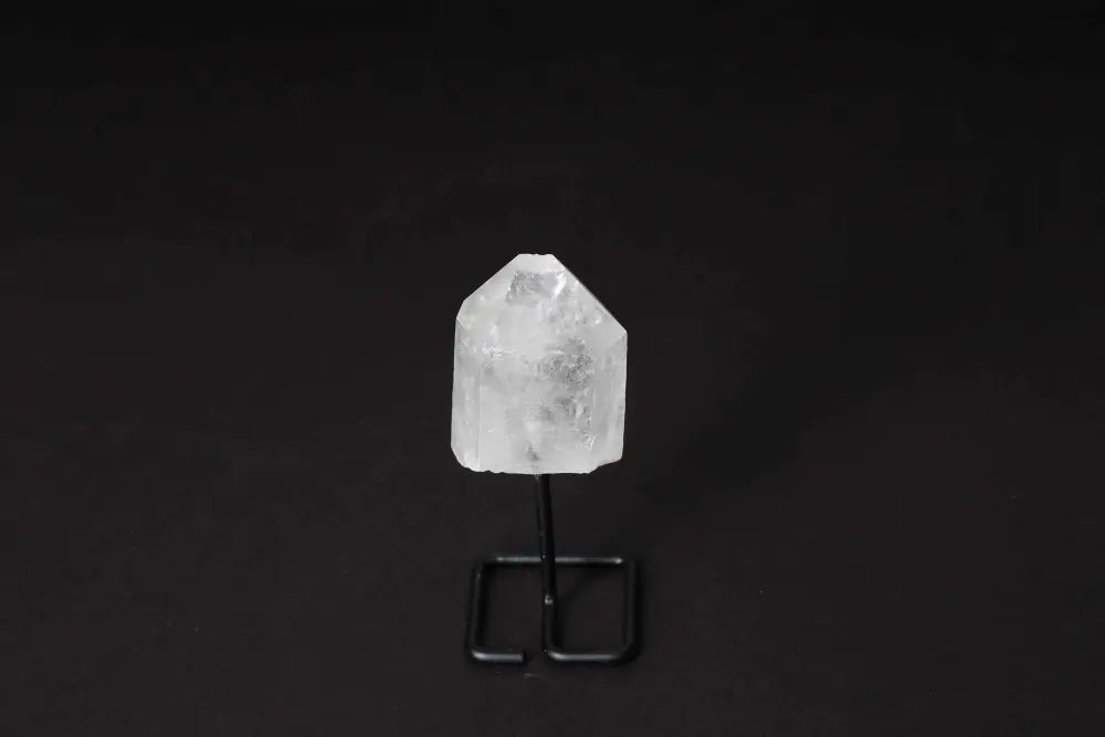 Clear Quartz Point on a stand for energy amplification and clarity in meditation and decor.