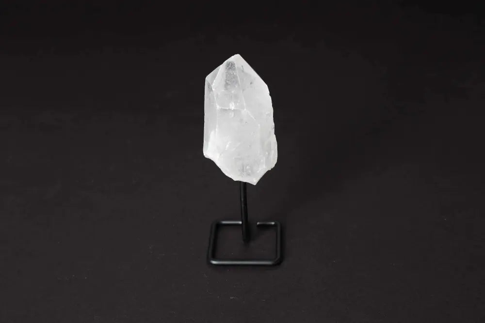 Clear Quartz point on modern stand for energy amplification and clarity, ideal for meditation and manifestation.