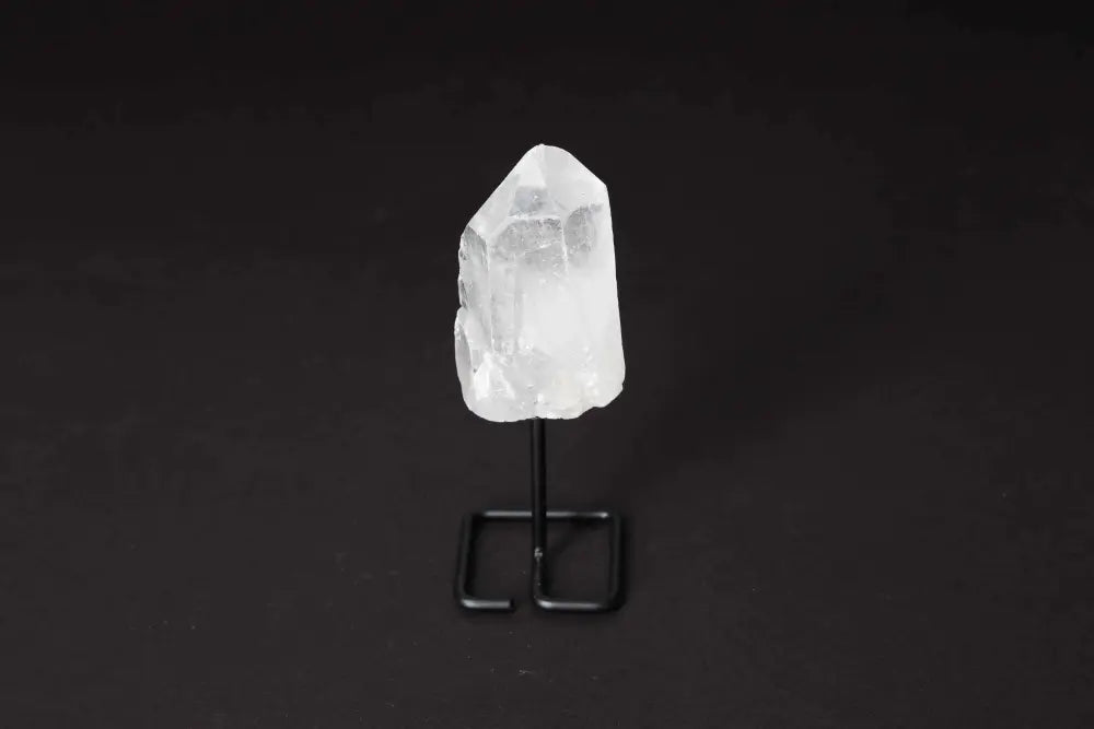 Natural clear quartz point on modern stand for energy amplification and clarity