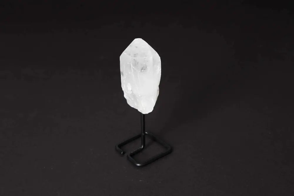 Natural Clear Quartz Point on elegant stand, perfect for energy amplification, meditation, and clarity enhancement.