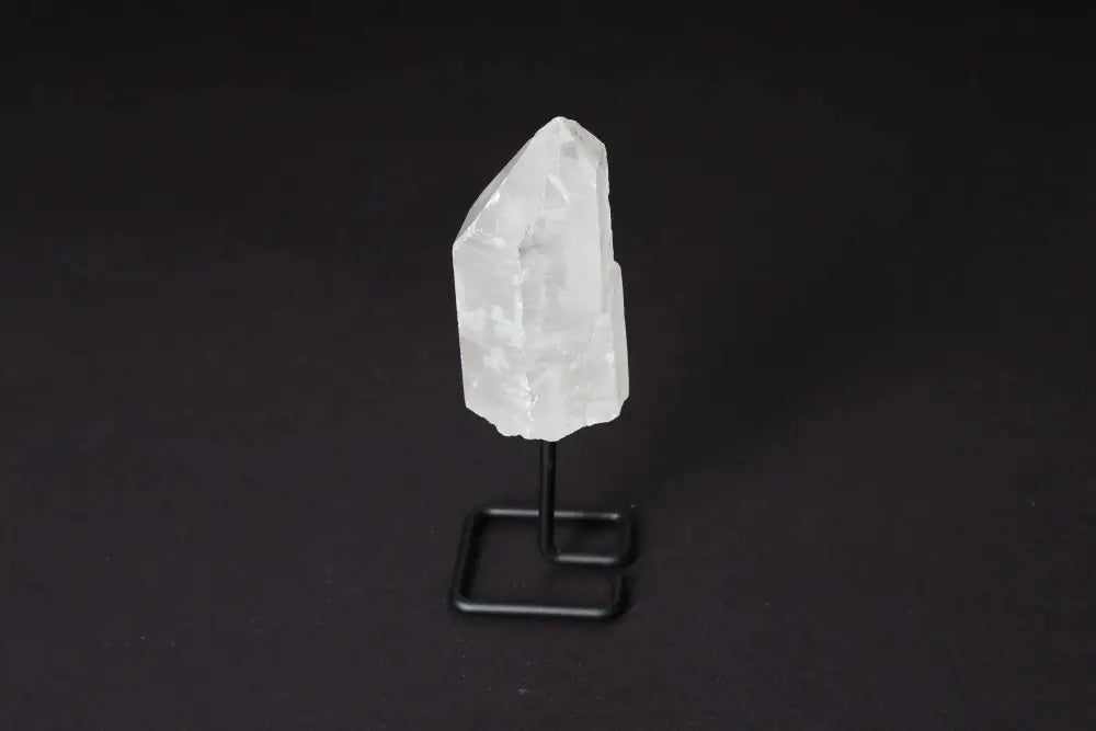 Natural Clear Quartz Point on modern stand for energy amplification and clarity, ideal for meditation and manifestation.