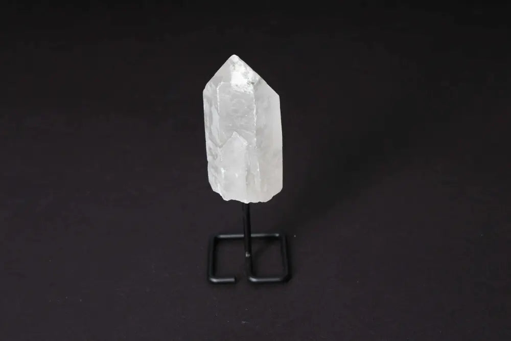 Clear Quartz point on modern stand, amplifying energy and clarity; perfect for meditation and energy work.