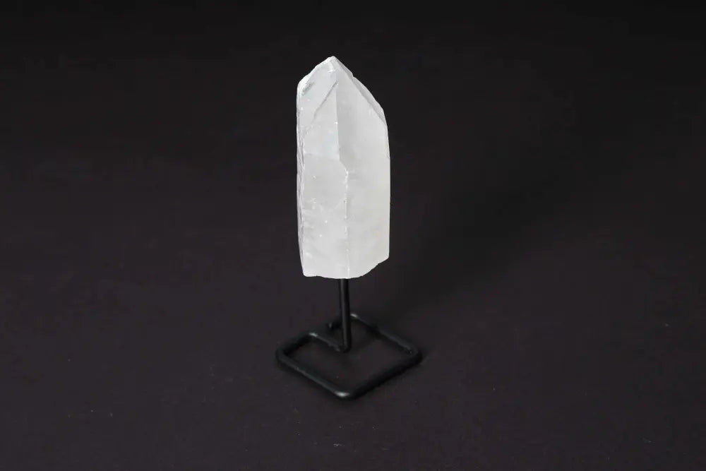 Natural Clear Quartz Point on stand for meditation, energy work, and clarity boosting.