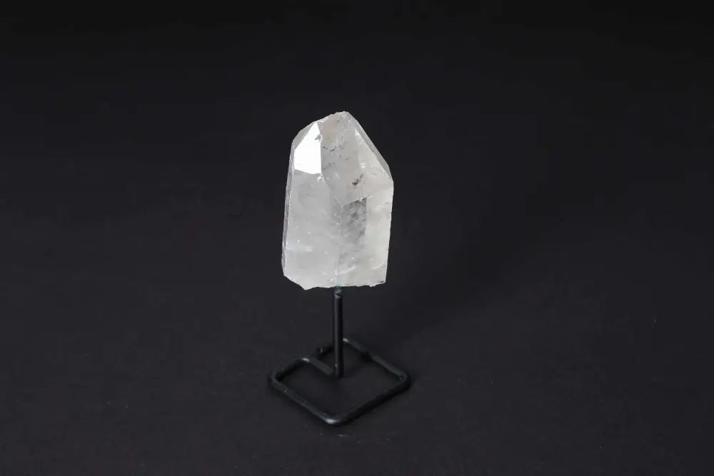 Natural Clear Quartz Point on stand for energy amplification and clarity, ideal for meditation and manifestation practices.
