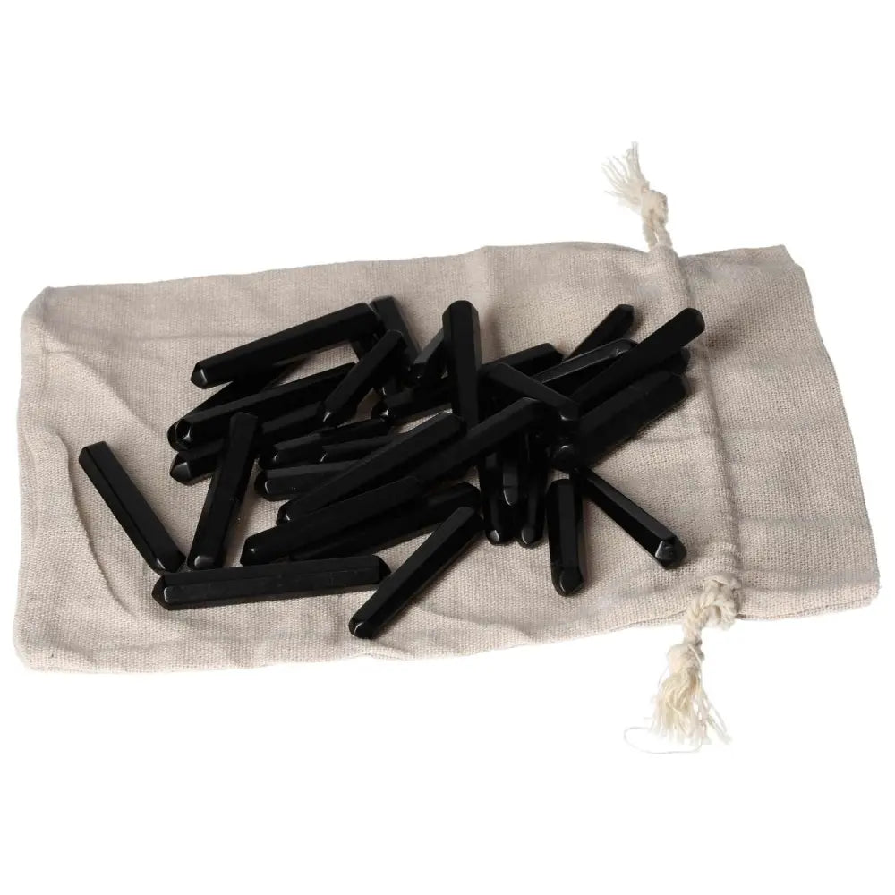 Obsidian Small Stics on a beige cloth bag, known for protective aura and energy absorption.