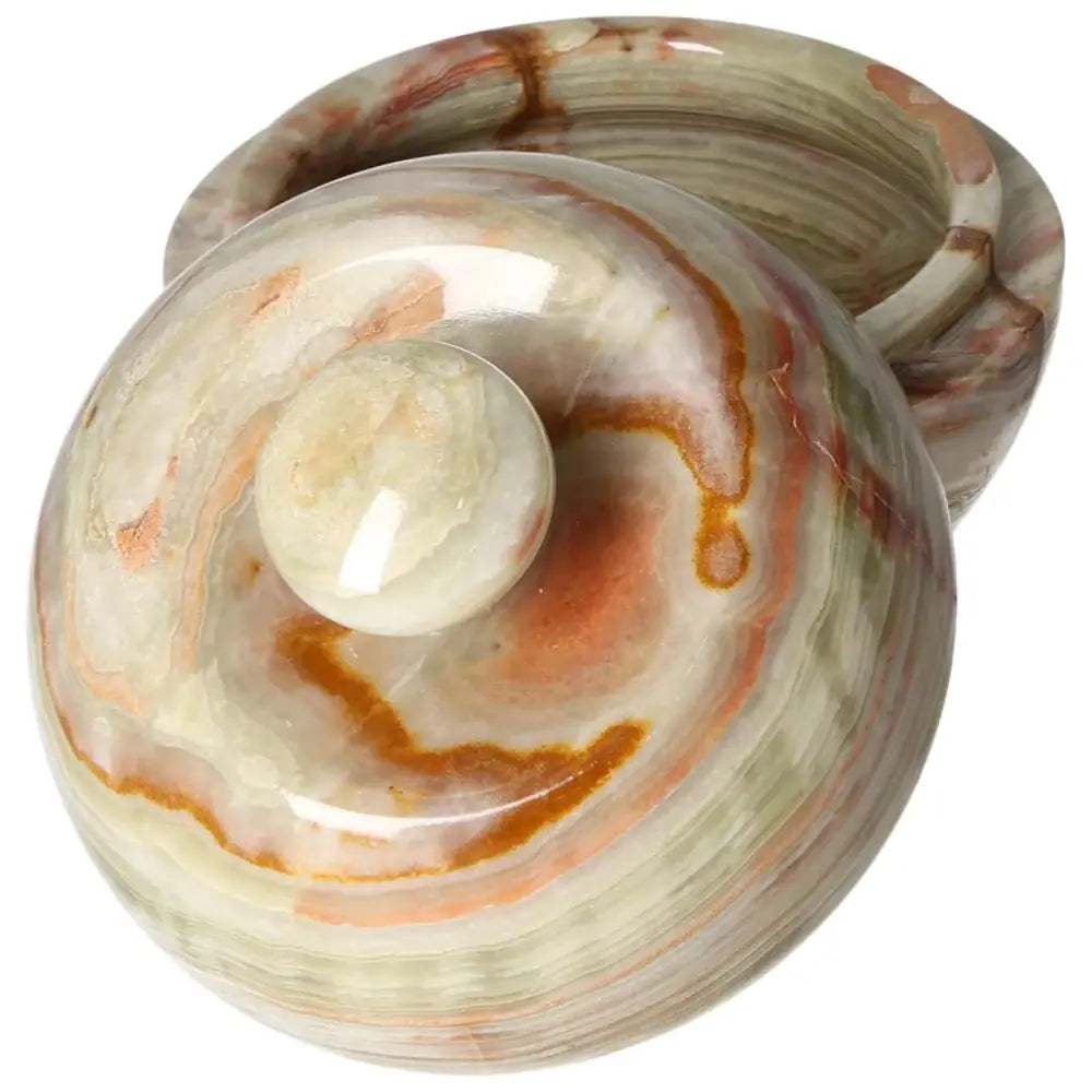 Polished onyx bowl with lid, showcasing unique veining and organic color variations, enhances décor with its elegant, translucent design.