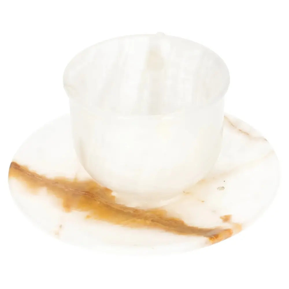 Off-white onyx coffee cup and plate set with unique natural patterns, polished to reflect ambient light for an elegant coffee experience.
