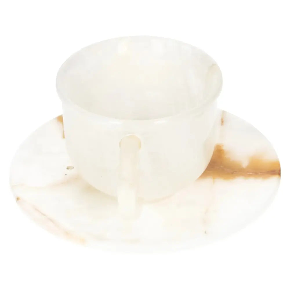 Exquisite off-white onyx coffee cup and plate set, showcasing unique patterns and a polished finish, perfect for elegant coffee rituals.