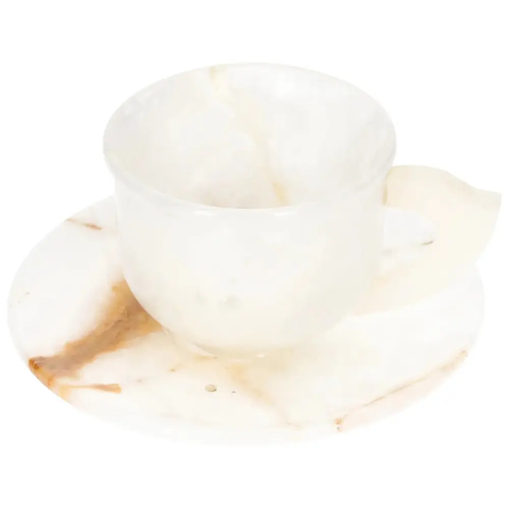 Elegant off-white onyx coffee cup and plate set, showcasing unique natural patterns, reflecting ambient light, perfect for elevating coffee rituals.