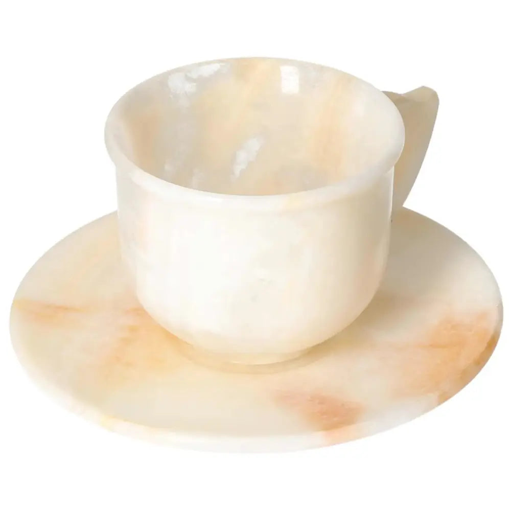 Elegant off-white onyx coffee cup and plate set showcasing unique natural patterns, reflecting ambient light for a sophisticated touch.