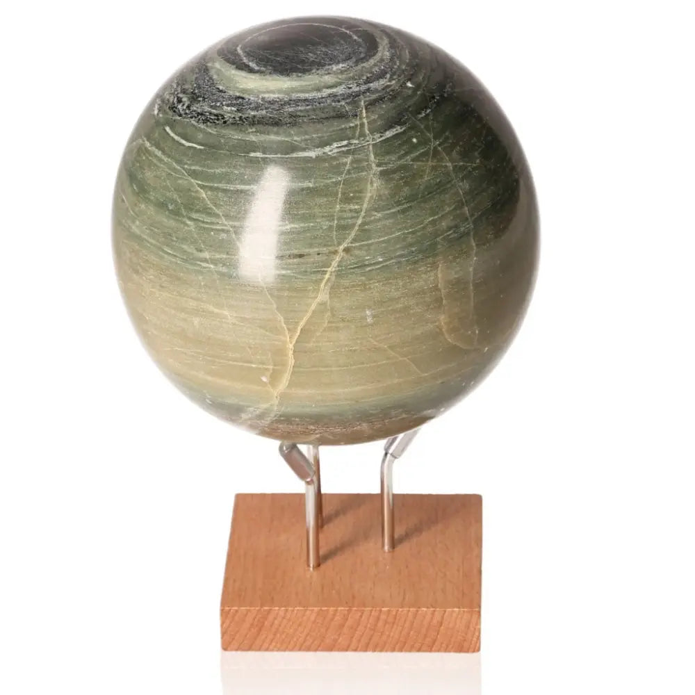 Elegant Onyx Sphere with glossy finish on a wooden stand, symbolizing resilience and strength. Perfect for home decoration and spirituality.