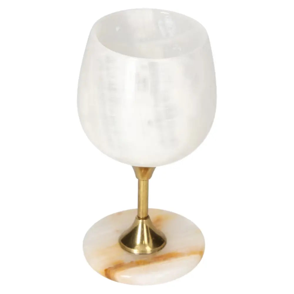 Exquisite onyx wine glass with natural veining, mounted on a brass stem, showcasing elegance and sophistication.