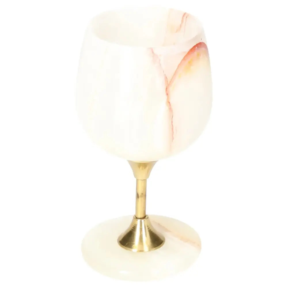 Luxury onyx wine glass with unique veining, elegant off-white color, and polished finish on a golden stem, ideal for sophisticated occasions.