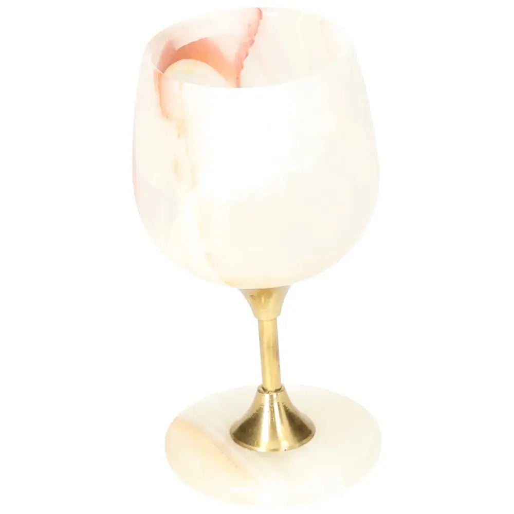 Exquisite onyx wine glass with unique off-white veining and a polished brass stem, ideal for adding elegance to any occasion.