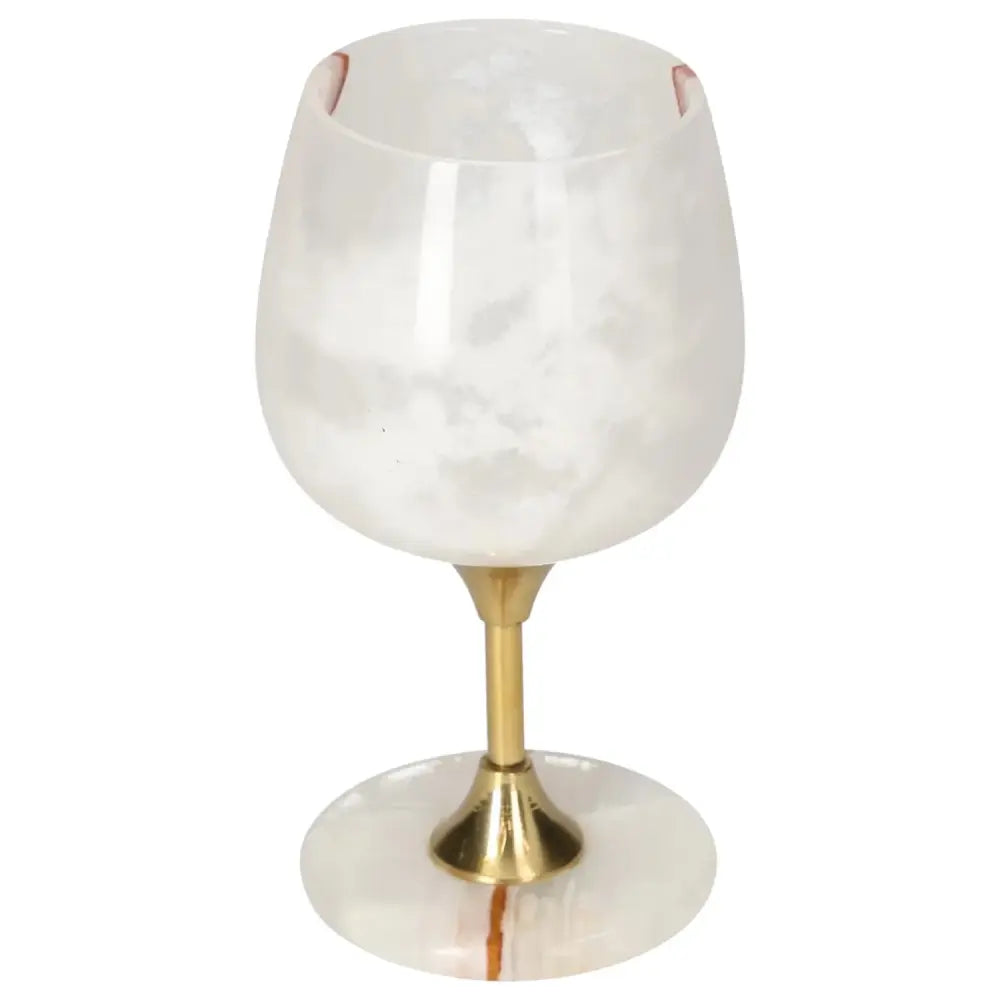 Elegant onyx wine glass crafted from premium off-white onyx, featuring unique veining and a polished brass stem; perfect for upscale dining.
