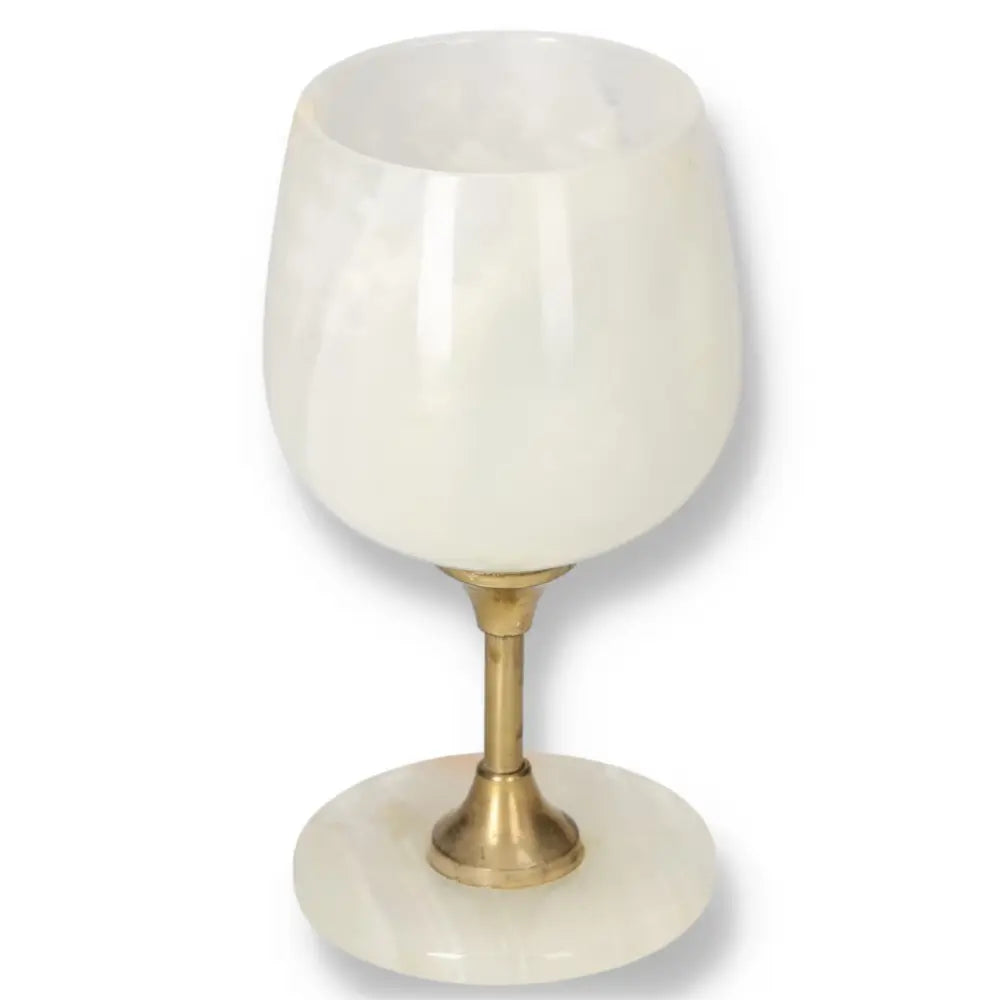 Exquisite off-white onyx wine glass with unique veining, featuring a polished finish and brass stem, ideal for elegant occasions.