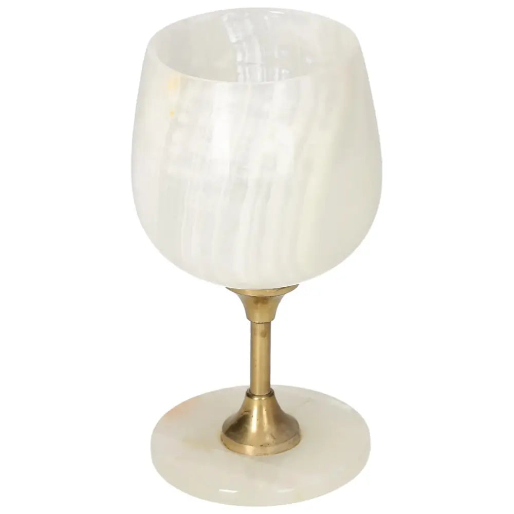 Elegant onyx wine glass with brass stem, showcasing unique veining and polished off-white stone for a sophisticated touch.