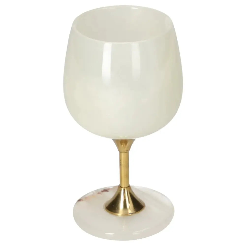 Elegant onyx wine glass with polished surface and brass stem, showcasing unique off-white color and veining for sophisticated dining.