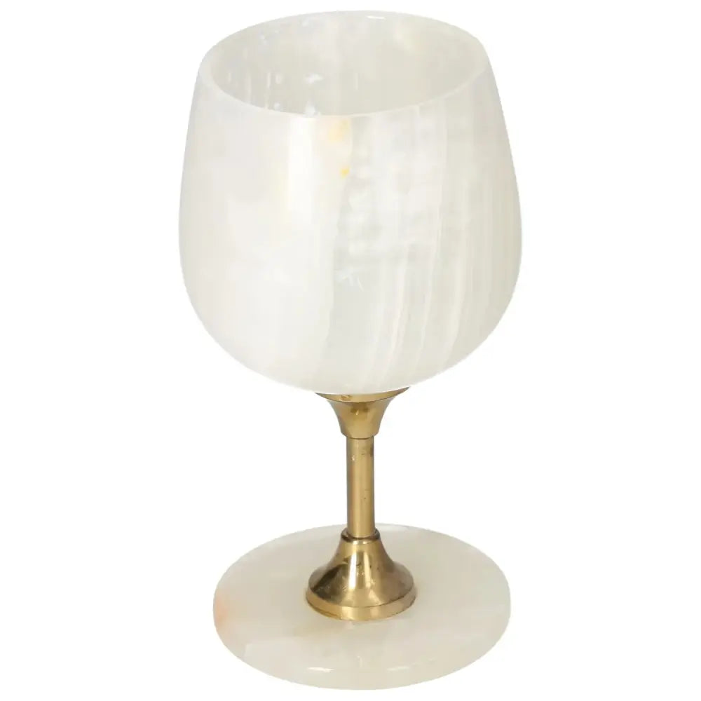 Elegant off-white onyx wine glass with unique veining and polished surface, featuring a sophisticated design and brass stem.