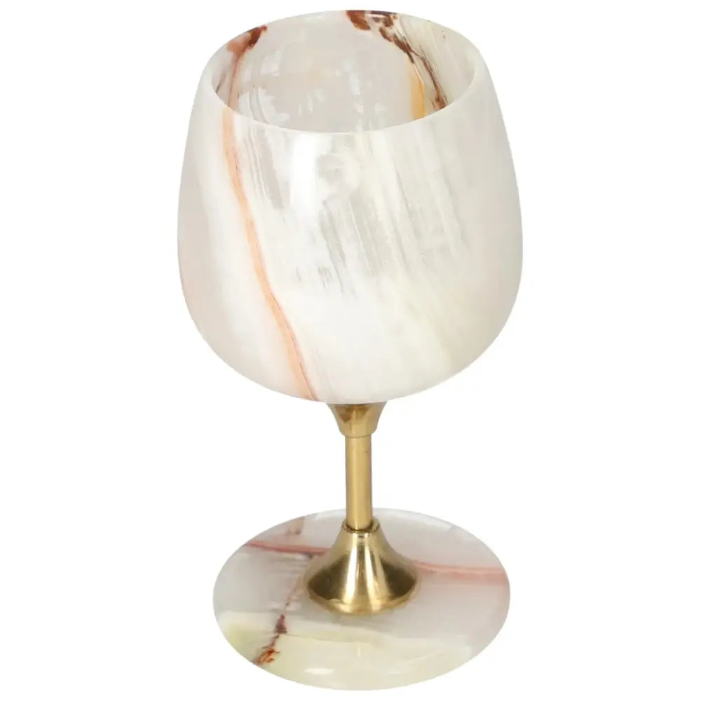 Exquisite onyx wine glass with polished surface and unique veining, perfect for elegant dining occasions.