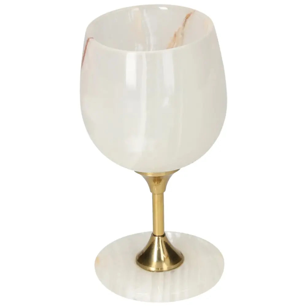 Onyx wine glass with polished off-white surface and golden stem, showcasing unique color variations and elegant design for sophisticated occasions.
