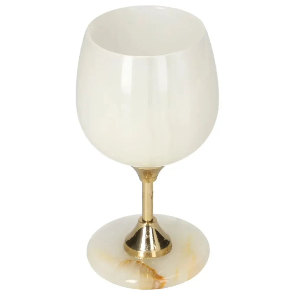 Exquisite off-white onyx wine glass with a gold stem, showcasing unique veining and elegant craftsmanship.