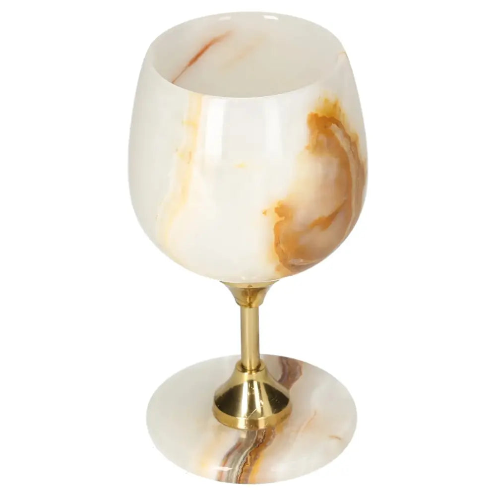 Elegant onyx wine glass with natural off-white veining, polished surface, and gold stem, ideal for sophisticated dining experiences.