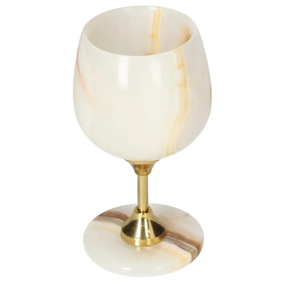 Luxurious onyx wine glass with golden stem, showcasing elegant off-white tones and unique veining for sophisticated occasions.