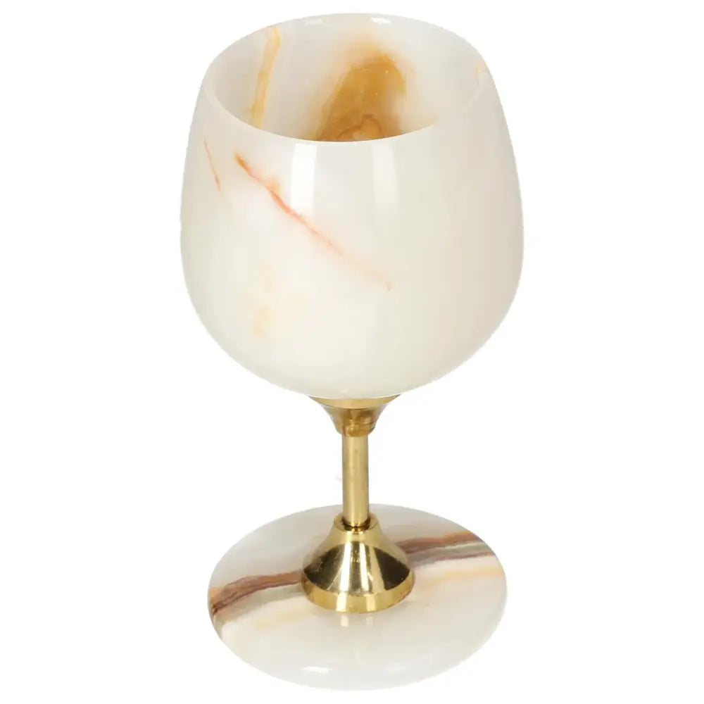 Exquisite off-white onyx wine glass with gold stem, showcasing unique veining and polished surface for an elegant dining experience.