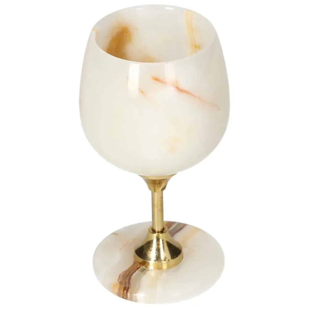 Exquisite off-white onyx wine glass with unique veining, polished surface, and gold stem, ideal for elegant occasions.