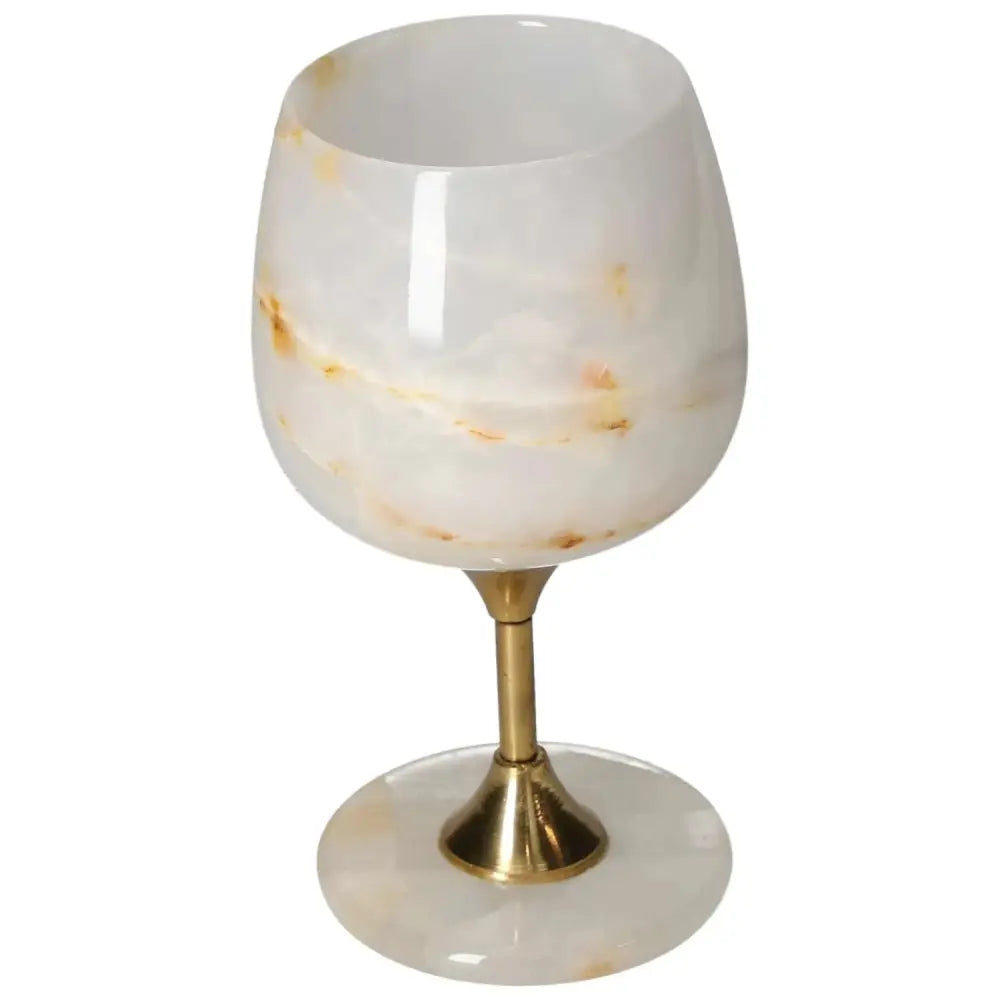 Exquisite off-white onyx wine glass with unique veining and a polished surface on a gold stem, perfect for elegant occasions.