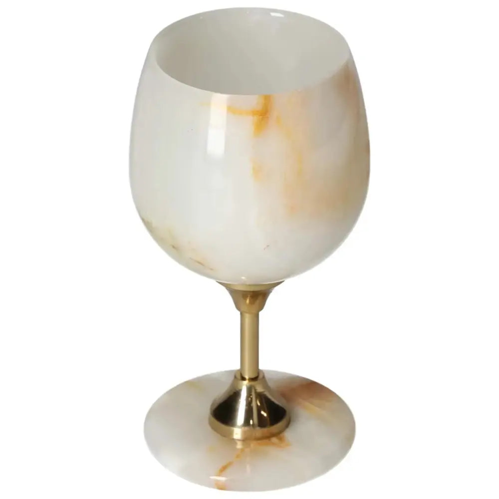 Elegant onyx wine glass with unique veining and a polished surface, featuring a golden stem, perfect for sophisticated occasions.