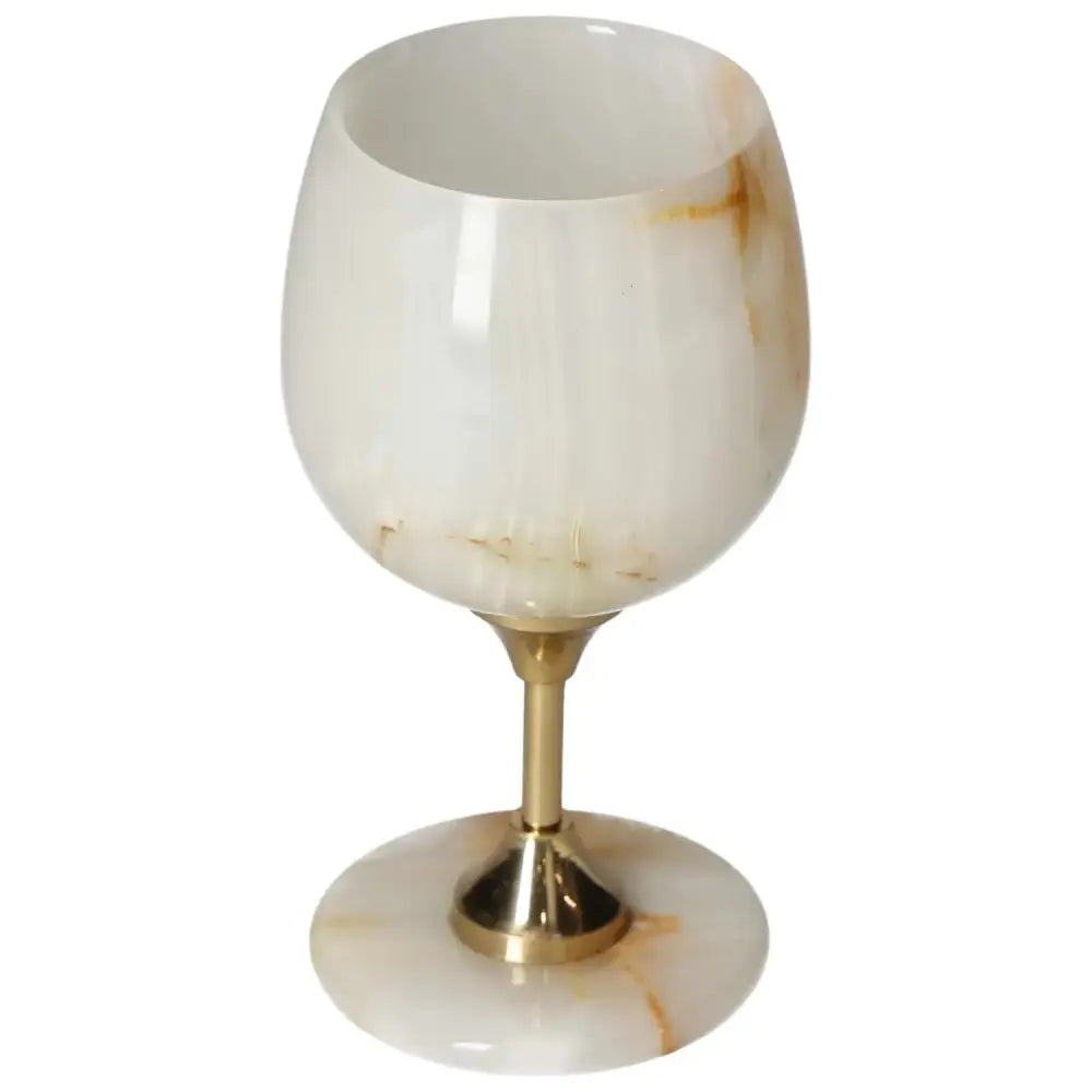 Exquisite onyx wine glass with unique off-white veining and a polished surface, elegant for refined occasions.
