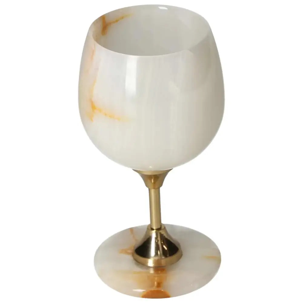 Elegant onyx wine glass with gold stem, showcasing unique off-white veining and smooth surface for sophisticated drinking.