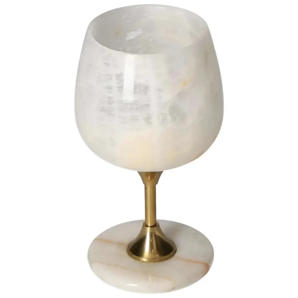 Exquisite off-white onyx wine glass with unique veining, polished surface, and elegant brass stem, perfect for fine drinking occasions.