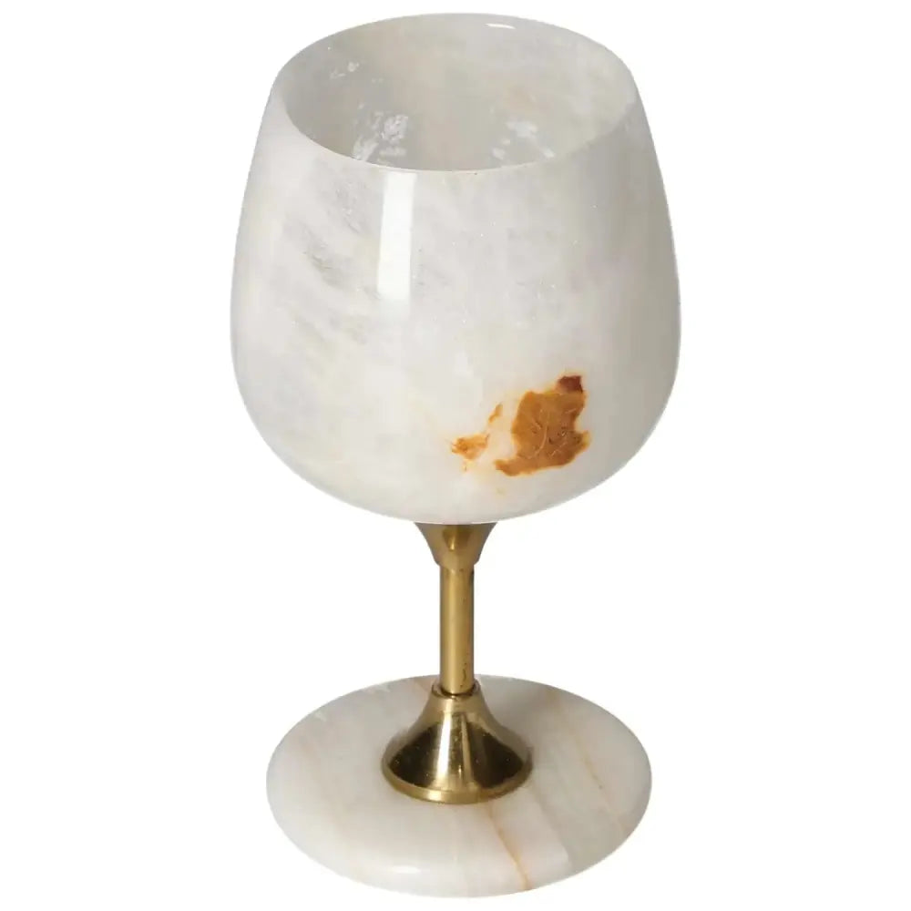 Exquisite onyx wine glass with off-white hue and unique veining, featuring a polished surface on a gold-toned stem.