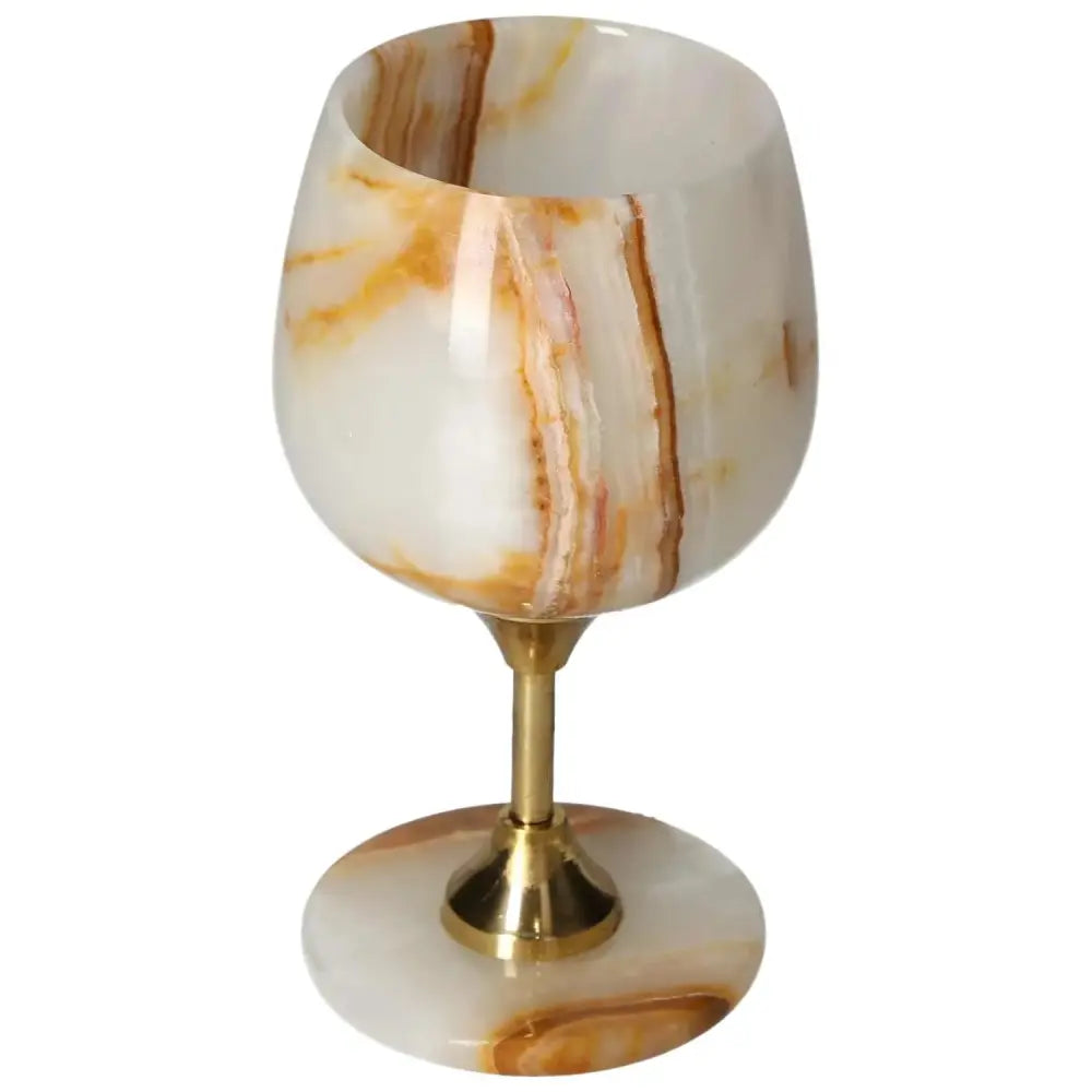 Off-white onyx wine glass with unique color veining and polished surface, enhancing elegance and sophistication for fine drinking.
