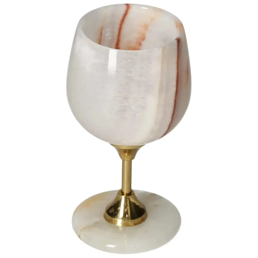 Exquisite off-white onyx wine glass with unique veining and a polished finish, featuring a sleek gold stem and base.
