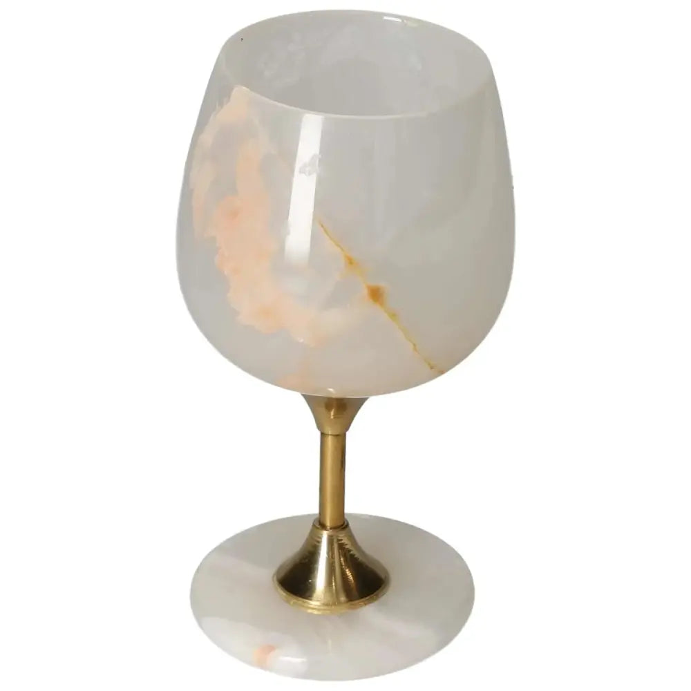Off-white onyx wine glass with gold stem, showcasing unique veining and elegant design, perfect for sophisticated dining.