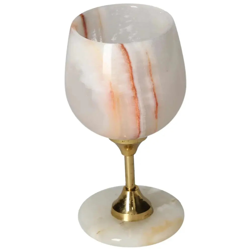 Exquisite onyx wine glass with unique off-white veining and polished gold stem, perfect for sophisticated wine enthusiasts.