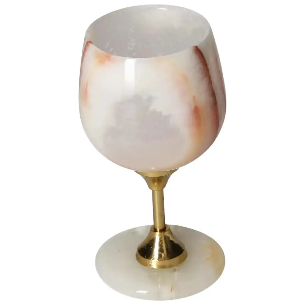 Luxurious onyx wine glass with unique veining and a polished surface, featuring a golden stem for added elegance.