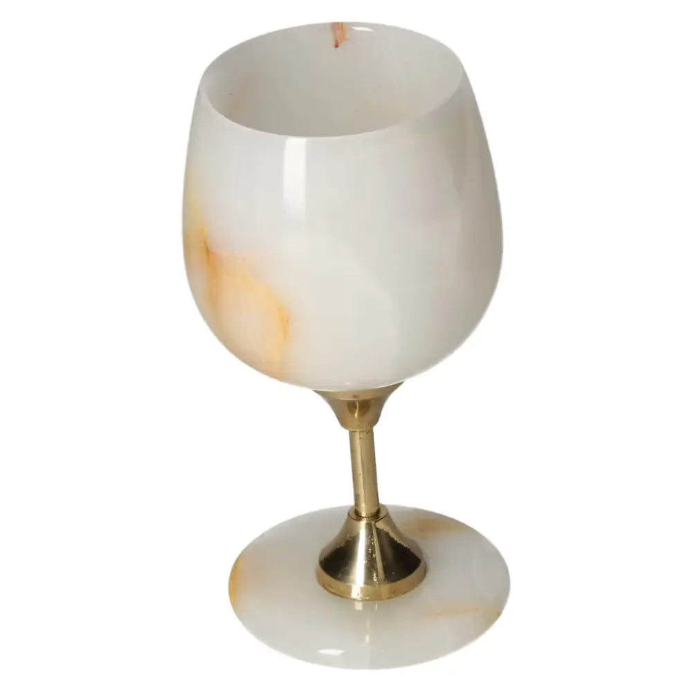 Elegant onyx wine glass featuring off-white tones and unique veining, with a polished brass stem, exuding sophistication and natural allure.