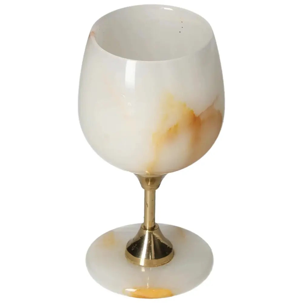 Elegant onyx wine glass with unique veining and a polished surface, featuring a gold-toned stem for sophisticated dining experiences.