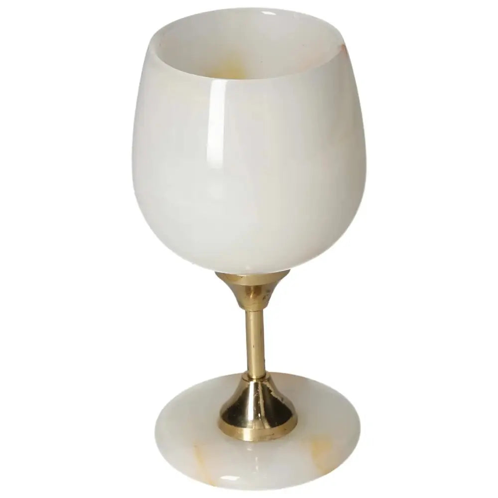 Elegant off-white onyx wine glass with gold accent, showcasing unique natural veining and polished surface for sophisticated dining.
