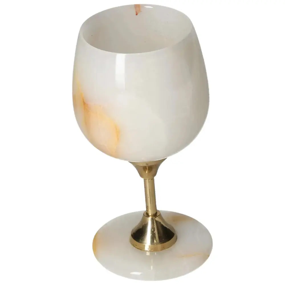 Elegant onyx wine glass with off-white and gold veining, showcasing a polished surface for a sophisticated drinking experience.
