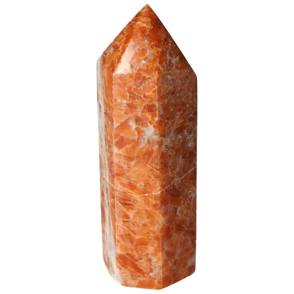 Orchid Calcite Obelisk from Sylvia Crystals with vibrant orange, peach, and creamy white hues, displaying luxury and grounding energy.