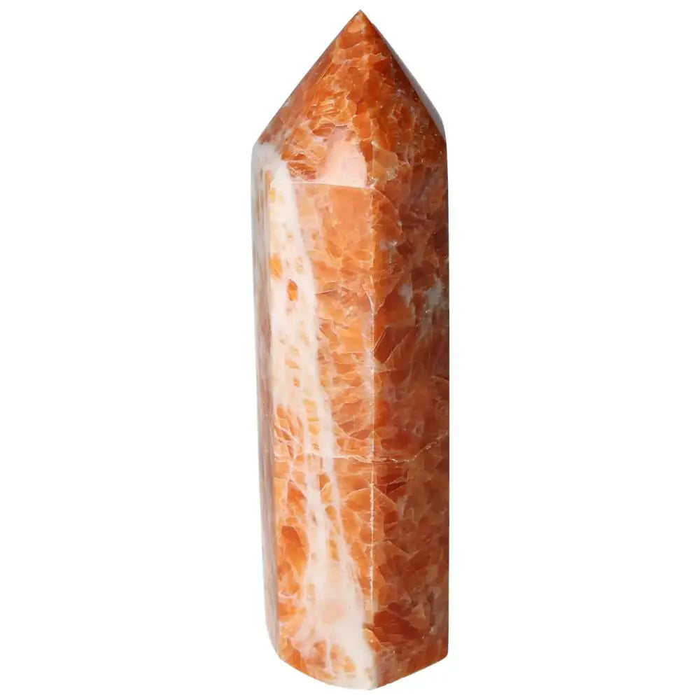 Orchid Calcite Obelisk with striking orange, peach, and creamy white hues from Sylvia Crystals, showcasing luxury and grounding energy.