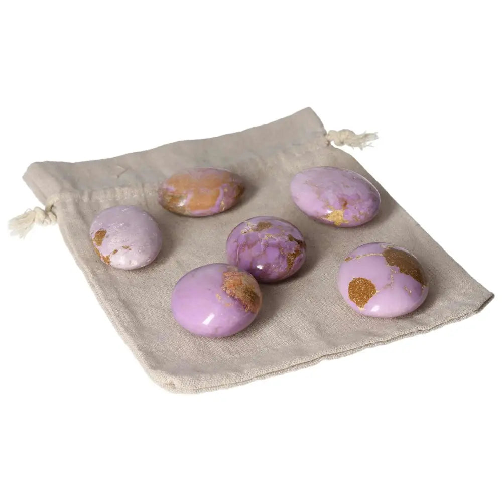 Set of six phosphosidente palmstones on a beige cloth bag.